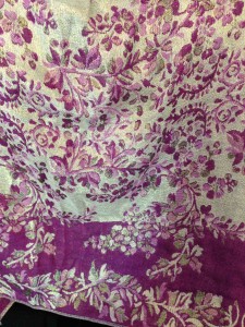 a cream, silver and light plum scarf with a floral pattern