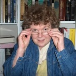 Author photo of Joanna Bourne. She has short curly hair and glasses.