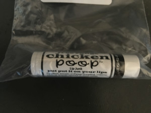 Photo of a tube of Chicken Poop Lip Balm. You want this. Seriously.