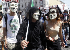 Demonstrators with Guy Fawkes masks march to the Portuguese parliament in Lisbon