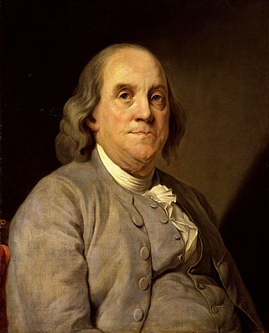 Color portrait of Benjamin Franklin, 1783. A heavy-set older man with receding hairline at the top of his head but shoulder-length hair that covers his ears. He is showing signs of age: baggy skin beneath his eyes and under his chin. His lips are very thin. He wears a gray suit (coat and waistcoat) with matching gray buttons, a narrow white cravat around his neck, tucked in, and white ruffles from his shirt extend out through the unbuttoned top section of his waistcoat.